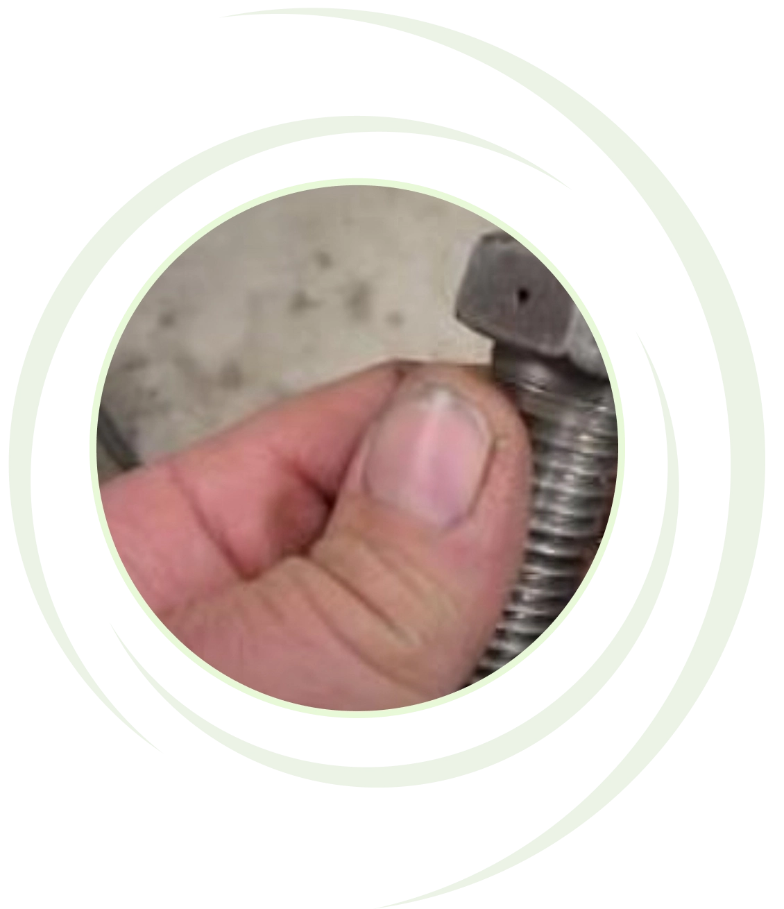 Hand holding a metal bolt closely.